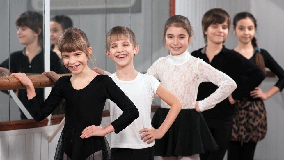 Boys and girls at ballet barre