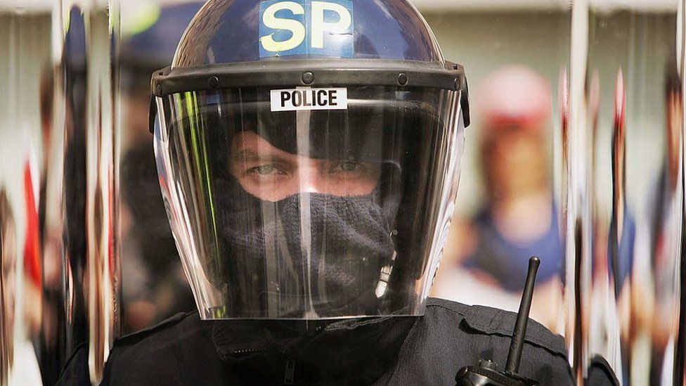 Police officer in riot helmet