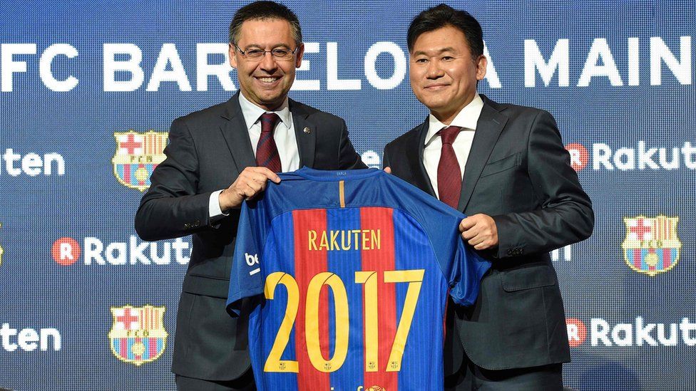 Barcelona's president Josep Maria Bartomeu (L) and CEO of Japanese company Rakuten Hiroshi Mikitani (R) display the FC Barcelona's new jersey after signing an agreement between FC Barcelona and Rakuten Inc., at Camp Nou stadium in Barcelona on November 16, 2016