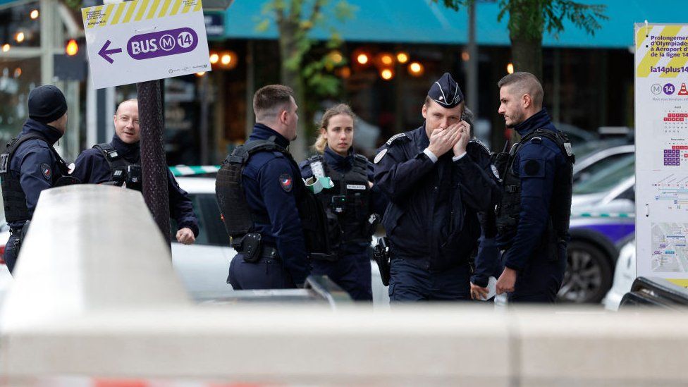 Police officers at the scene of the shooting of a woman in Paris, 31 October