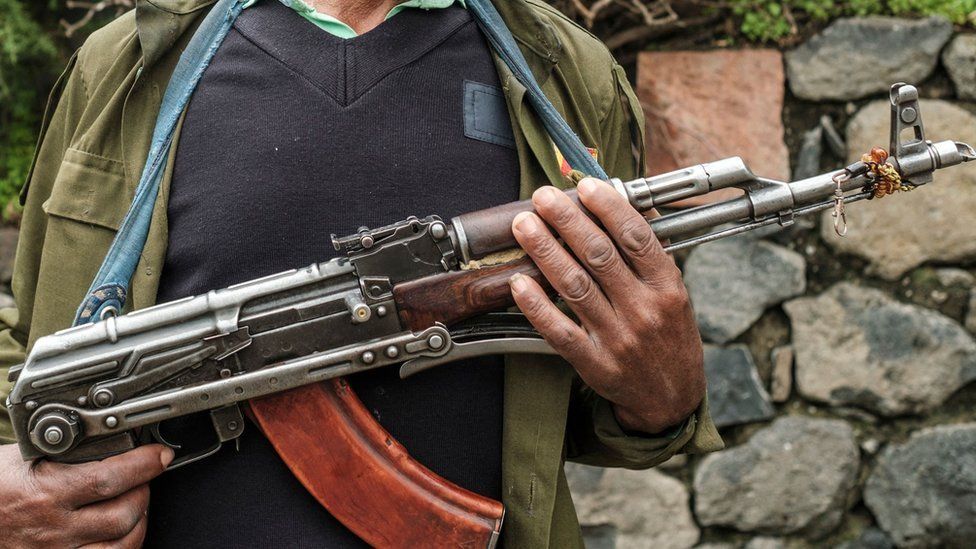 A member of the Amhara militia stands with his gun during a graduation ceremony