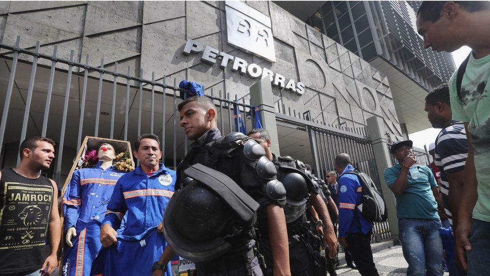Policemen and protesters outside the Petrobras headquarters in Rio de Janeiro