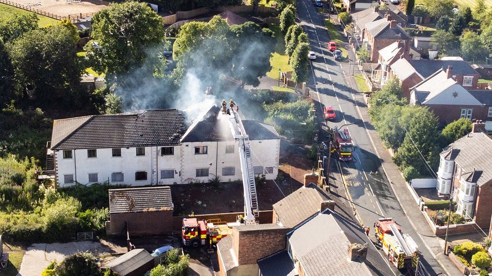 Aerial view of the former care home on fire