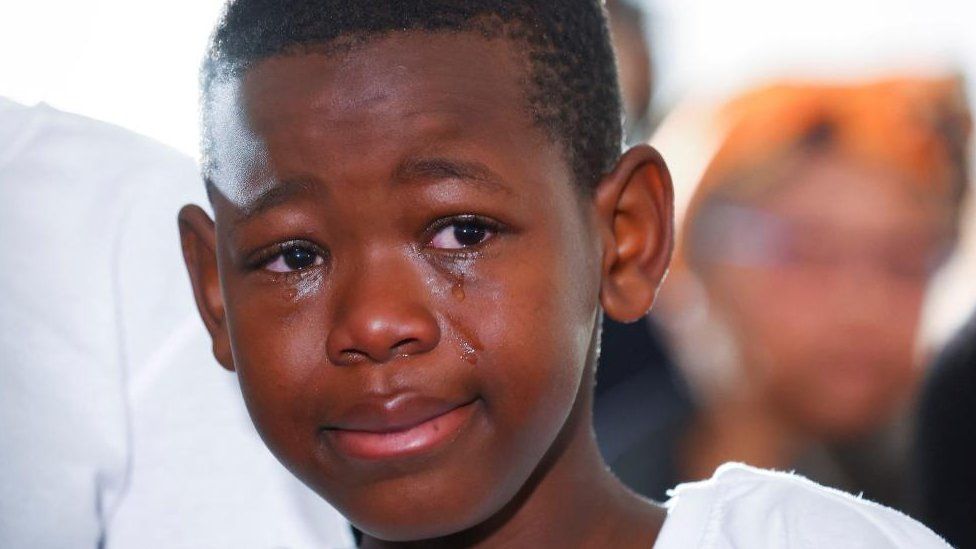 A child crying at the funeral in East London, South Africa - 6 July 2022
