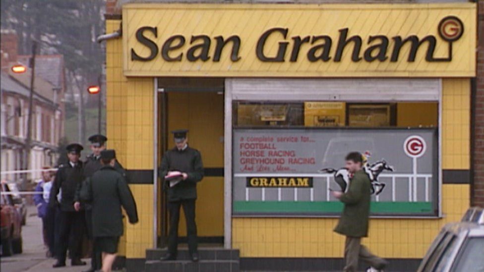 Police officers at Sean Graham betting shop after the shootings in February 1992