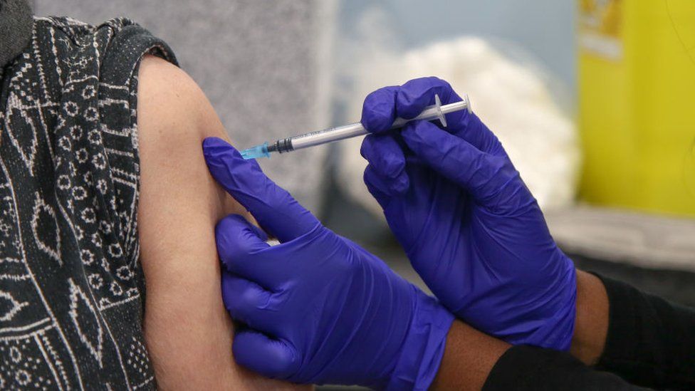 A woman receives her second booster Covid jab at a vaccination centre in London in spring 2022