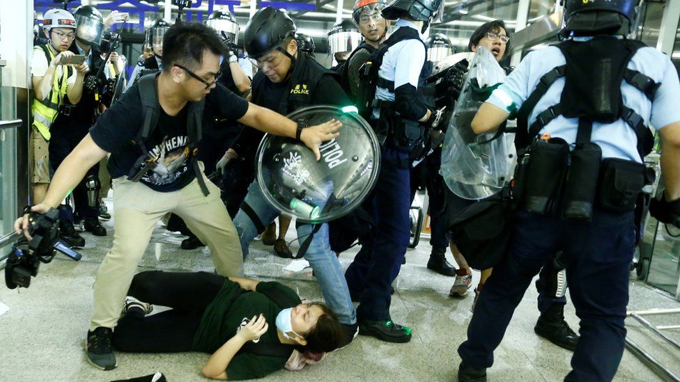 Police clash with anti-government protesters at the airport in Hong Kong