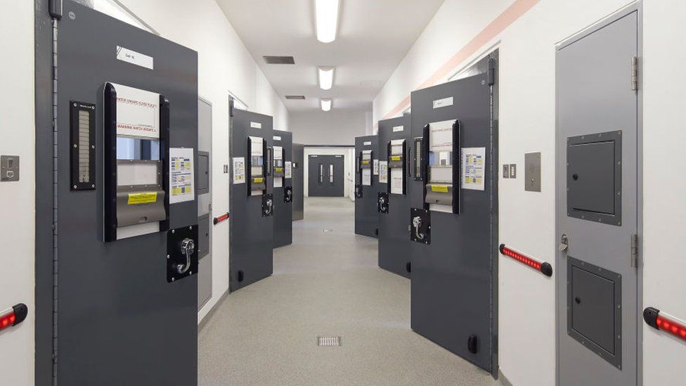 Corridor with custody cell doors - Keynsham Custody Suite