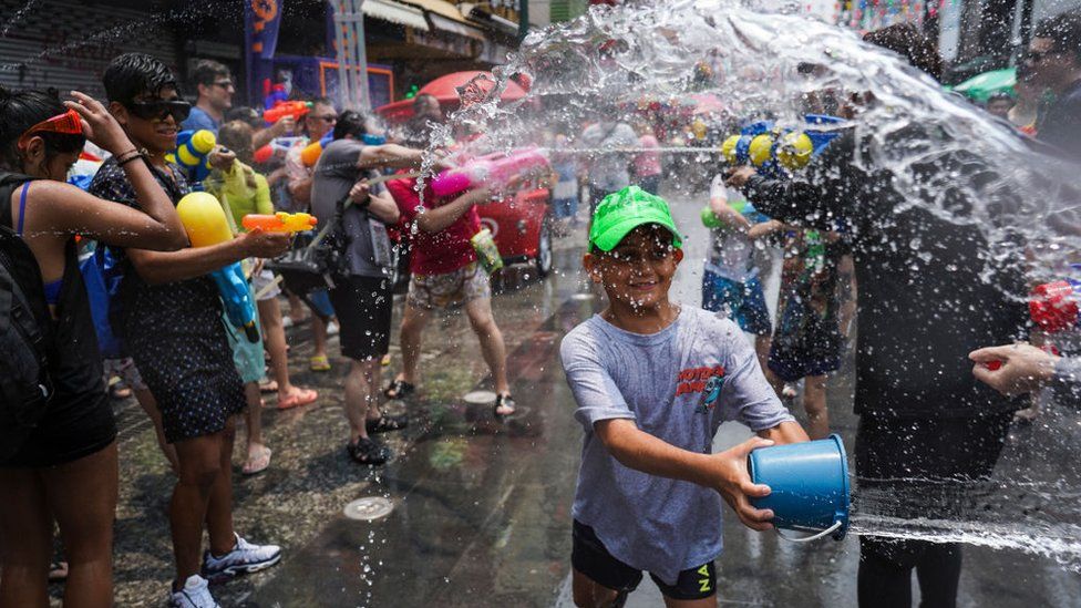 A group of children spraying water from water pistols