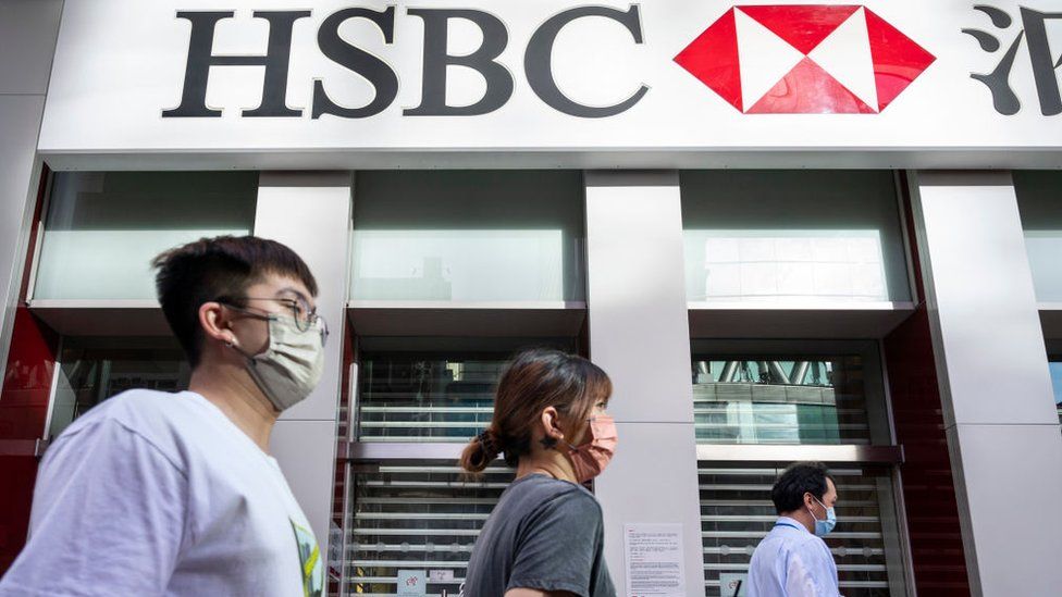 Pedestrians walk past the British multinational banking and financial services holding company, HSBC in Hong Kong.