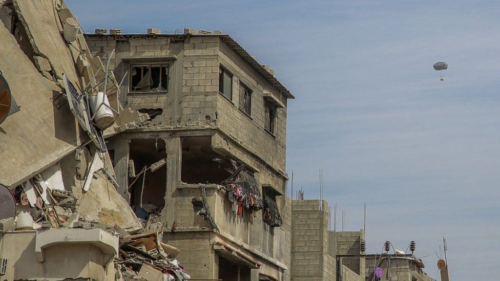 An aid package is seen parachuting into Gaza on Friday