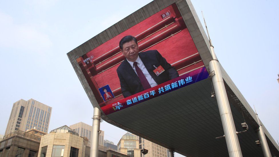 A large screen displays Chinese President Xi Jinping attending the closing session of the National People's Congress (NPC), in Beijing, China, 11 March 2021