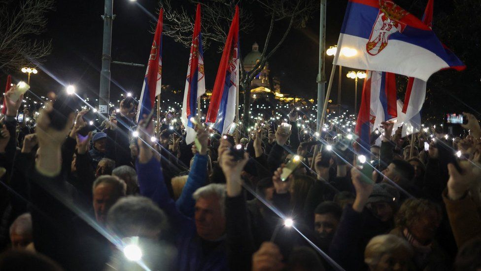 Protesters in Belgrade wave their mobile phone flashlights. Photo: 24 December 2023