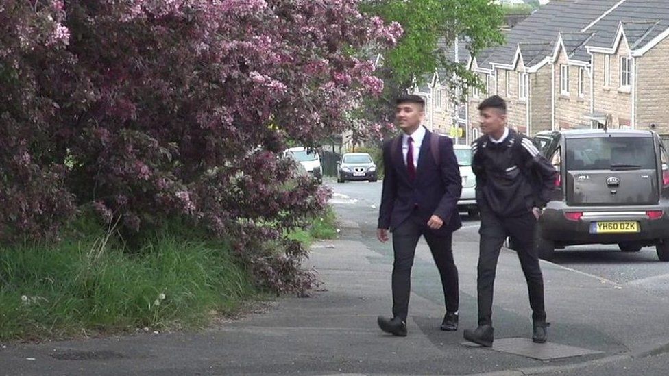 Two people walking in Bradford