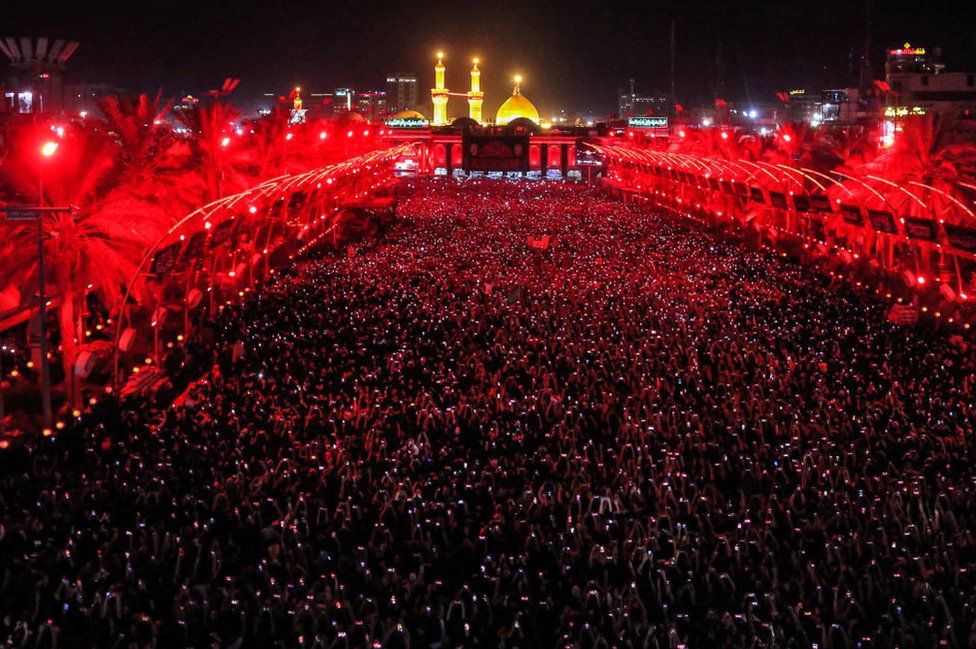 Muslim devotees gather during the flag-changing ceremony at the shrines of Imam Hussein and Imam Abbas in Iraq's central shrine city of Karbala on July 18, 2023