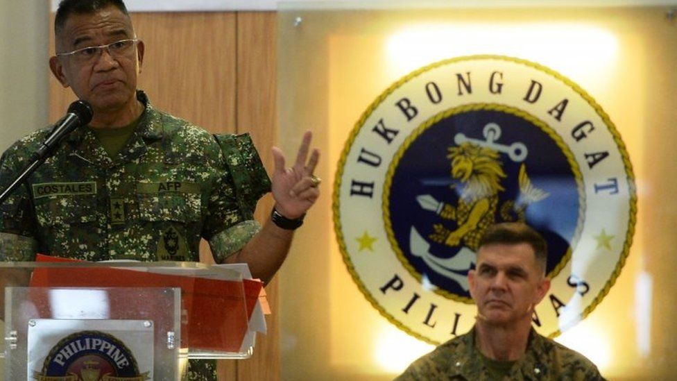Philippines marines commandant Major General Andre Costales (L) delivers a speech beside US marines Brigadier General John Jansen during the opening ceremony of the Amphibious Landing Exercise (PHIBLEX) at the marines headquarters in Manila on October 4, 2016.
