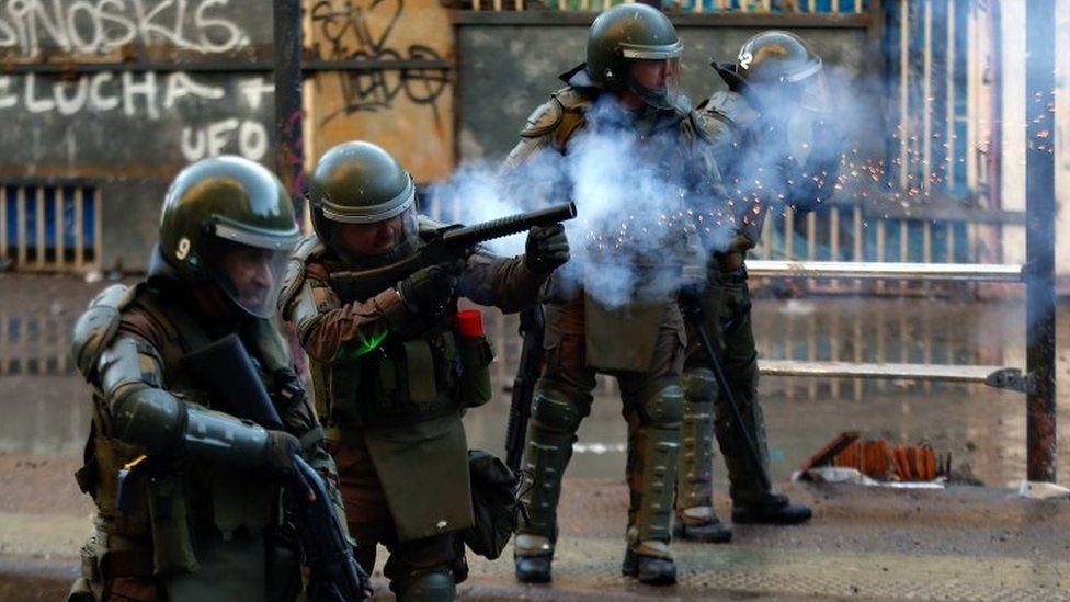 Carabineros fire tear gas on protesters during demonstrations at Plaza Baquedano, in Santiago, Chile, 15 November 2019.