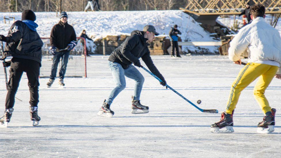 Фигуристы играют в хоккей в парке Мерланд недалеко от города Эйндховен 13 февраля 2021 года