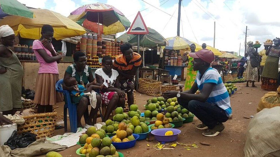 Lawrence talking to market traders