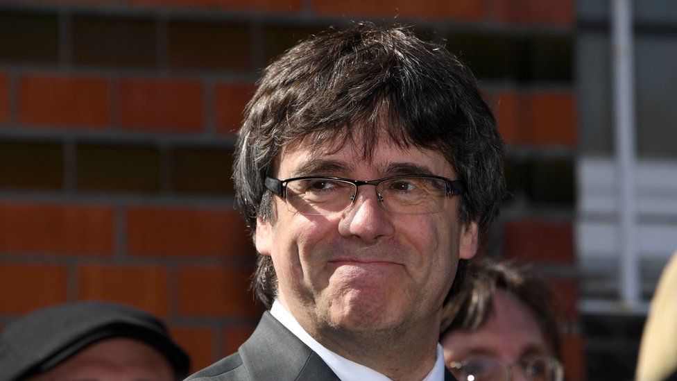 Catalonia"s former leader Carles Puigdemont speaks to the press as he leaves a detention centre in of Neumuenster, northern Germany, on April 6, 2018