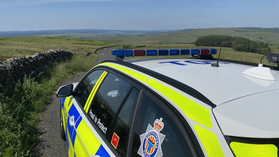 Northumbria police car with rural view