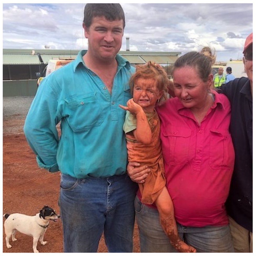 The girl and her family and dog after she was found in the Australian outback