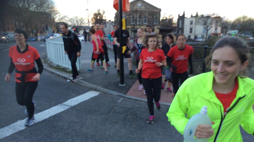 runners running over a road