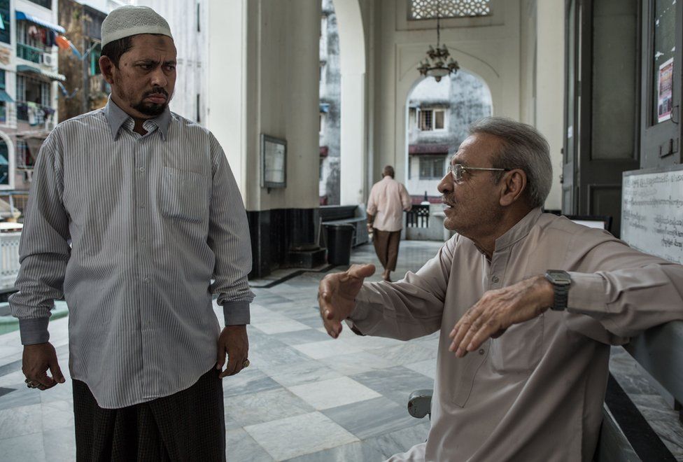 Farooq speaks with a local Muslim man at the Shia Mughal Mosque in downtown Yangon, Myanmar, November 19, 2015