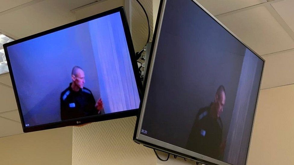 Russian opposition leader Alexei Navalny is seen on screens via video link before a court hearing, 29 Apr 21
