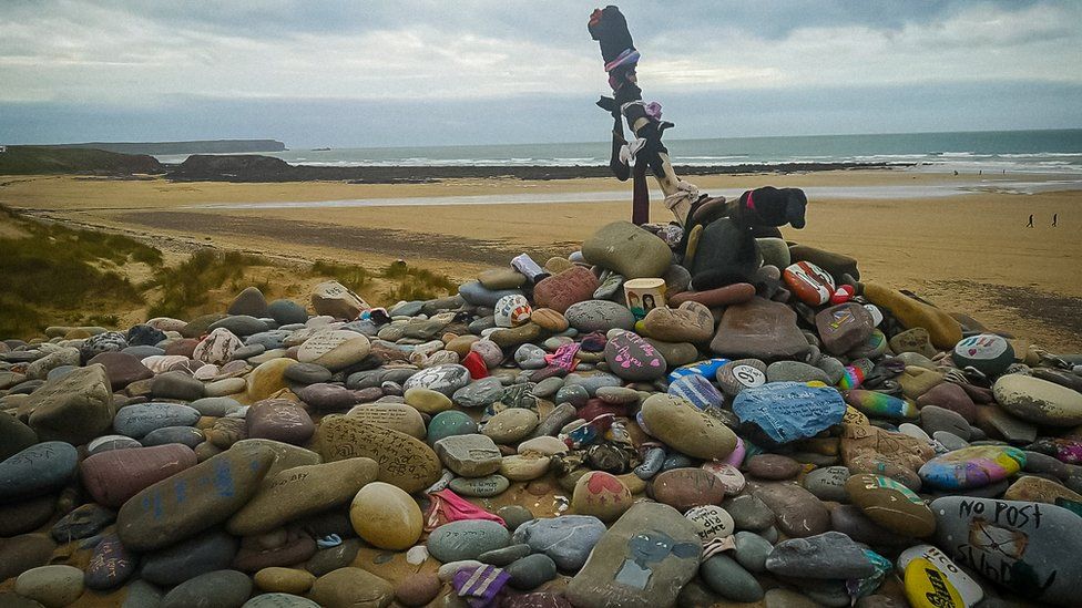 Pebbles and grave stone at Freshwater West