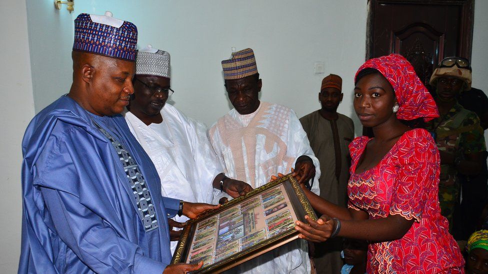 Governor Kashim Shettima receiving a 'thank you' gift from Glory Dama, on behalf of the 21 Chibok schoolgirls freed by Boko Haram in October, 2016.