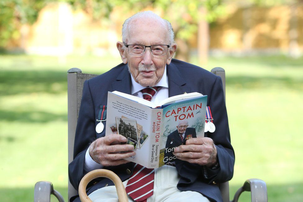 Capt Sir Tom Moore reads a copy of his autobiography Tomorrow Will Be A Good Day