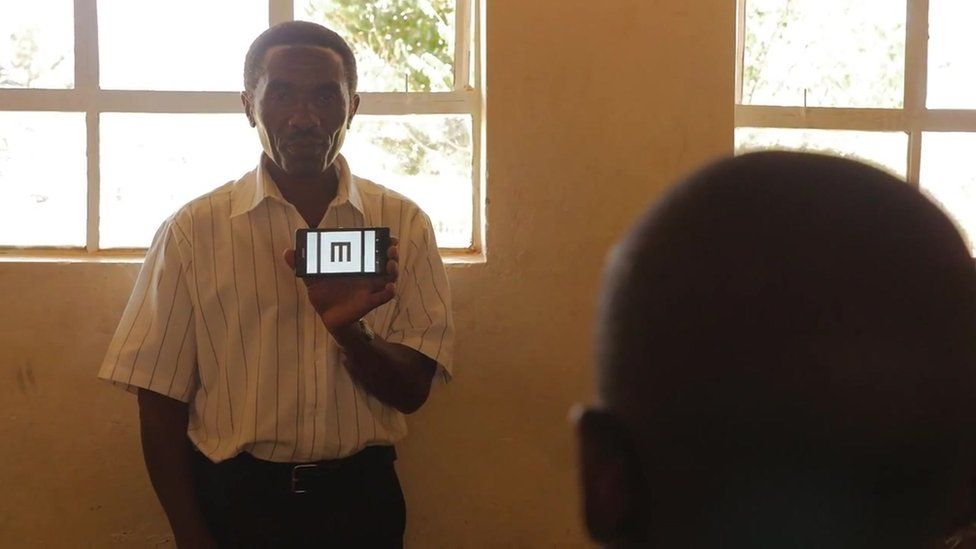 Picture of a teacher using the Peek app to test eye sight