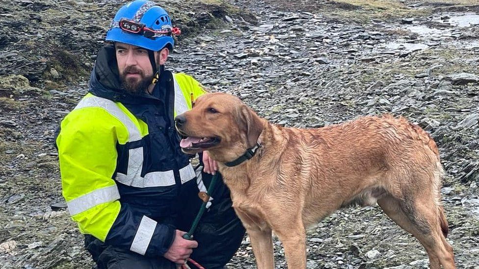 Rum the dog with a member of the coastguard rescue team