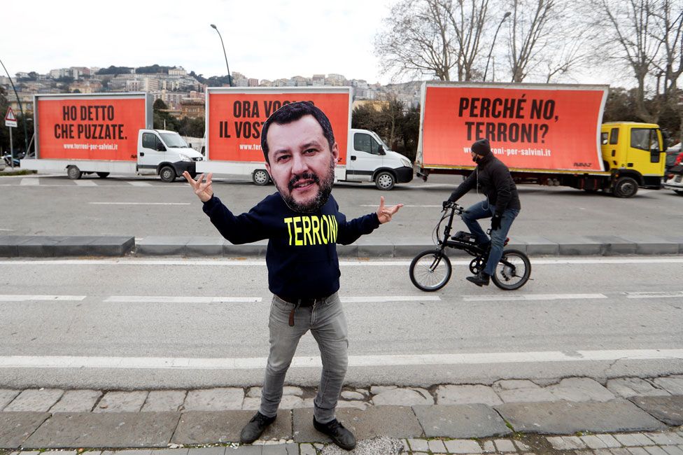 Three vans bearing billboards in Naples