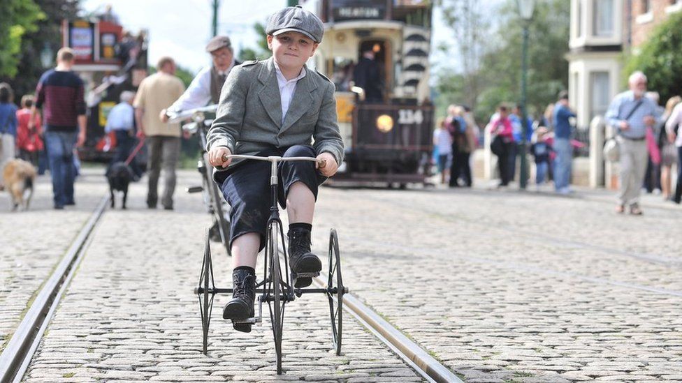A boy ride a 1930's tricycle