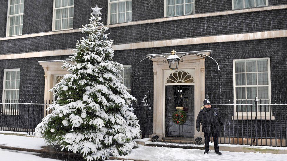A policeman stands outside 10 Downing Street in the snow