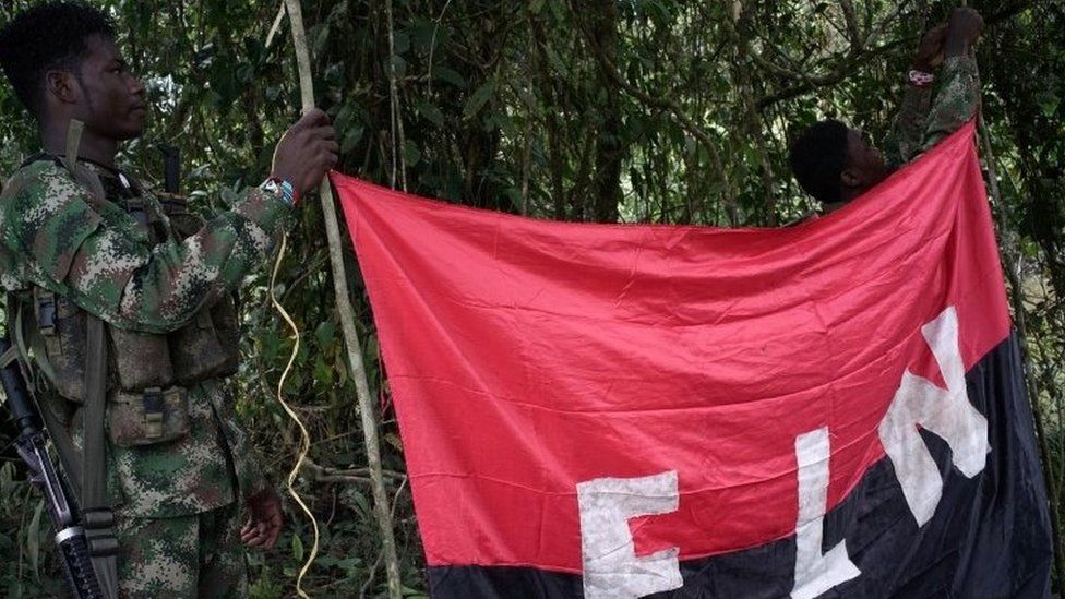 Rebels of the National Liberation Army (ELN) hold a banner in the north-western jungles in Colombia, August 30, 2017.
