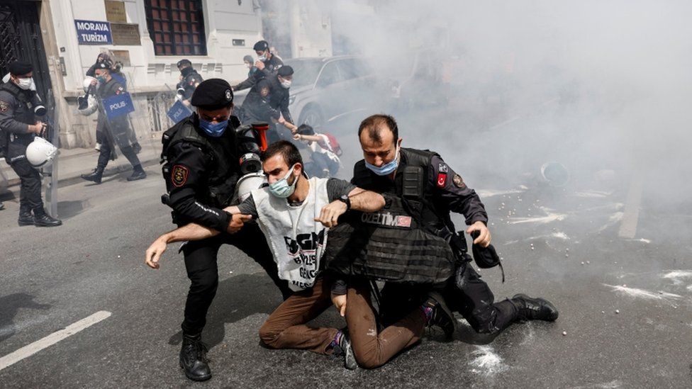 Riot police officers detain demonstrators as they attempt to defy a ban and march on Taksim Square