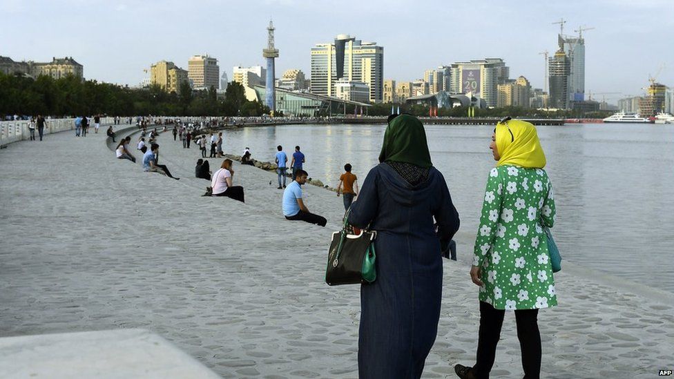 Two women in headscarves take a walk along Baku's seafront