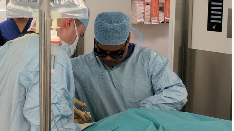 Dr Ahmed operating on a patient while wearing Snap spectacles