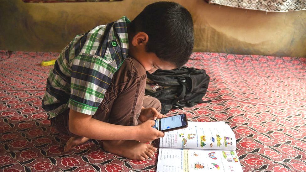 A Kashmiri student listen to the lecture (voice) of his teacher during an online class via Zoom app as schools remain closed amid the fight against the COVID-19 outbreak in Kashmir.