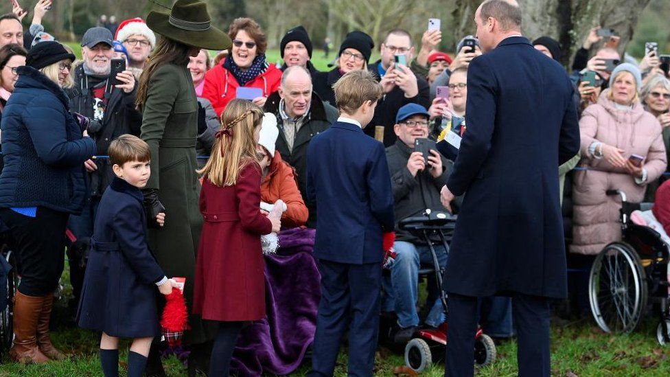 The Prince and Princess of Wales and their children greeting crowds at Sandringham