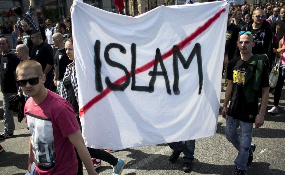 Participants hold a banner with the crossed out lettering 'Islam' during an anti-immigration rally organised by an initiative called 'Stop Islamisation of Europe' and backed by the far-right 'People's Party-Our Slovakia' on June 20, 2015 in Bratislava, Slovakia