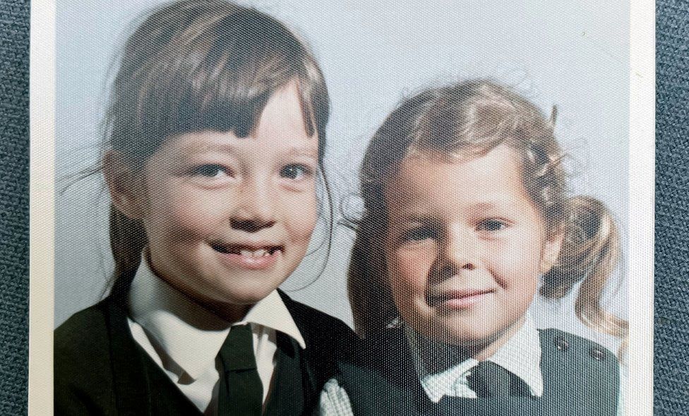 Julia (left) pictured in a school photo with her younger sister, Ruth (right)