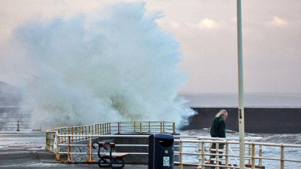 Wave crashes against promenade in Aberystwyth, Ceredigion, Wales