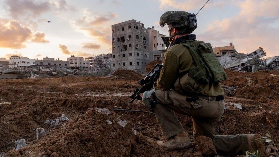 Israeli soldier takes position in the Gaza Strip, amid the ongoing conflict between Israel and the Palestinian Islamist group Hamas,