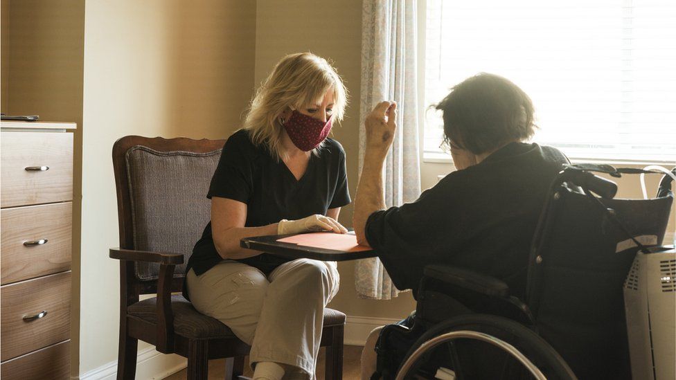 A care home worker with a resident