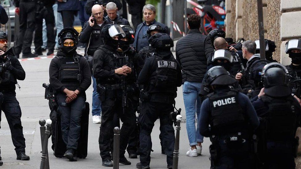 French police and members of French special police forces of Research and Intervention Brigade (BRI) secure the area