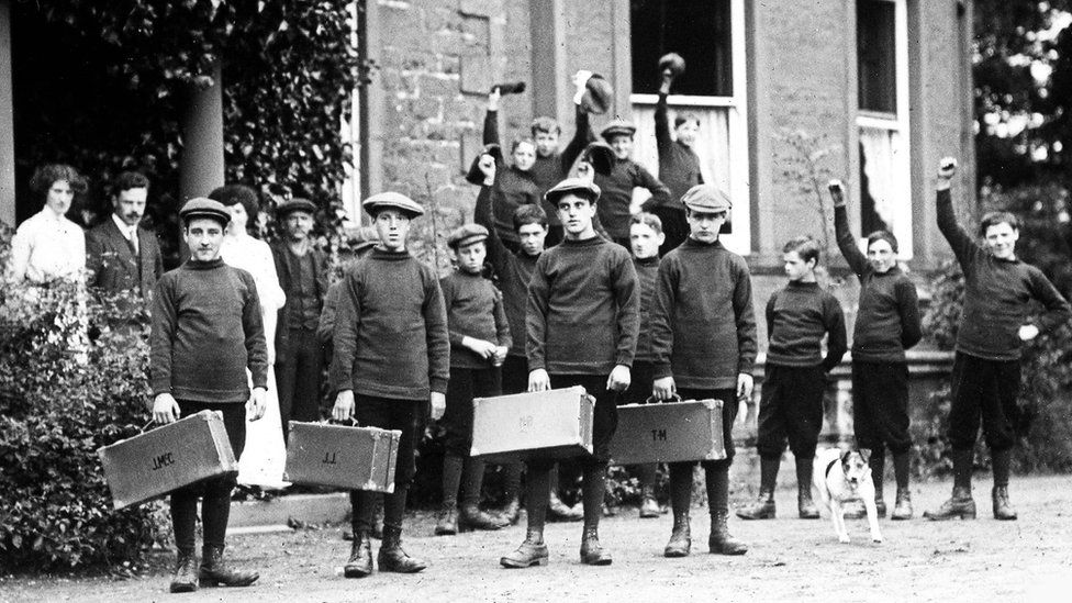 British Home Children holding suitcases
